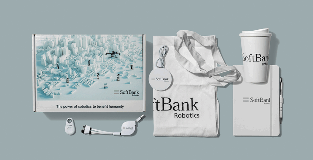 Fintech merchandise grey background featuring tote bag, USB, boxs all branded