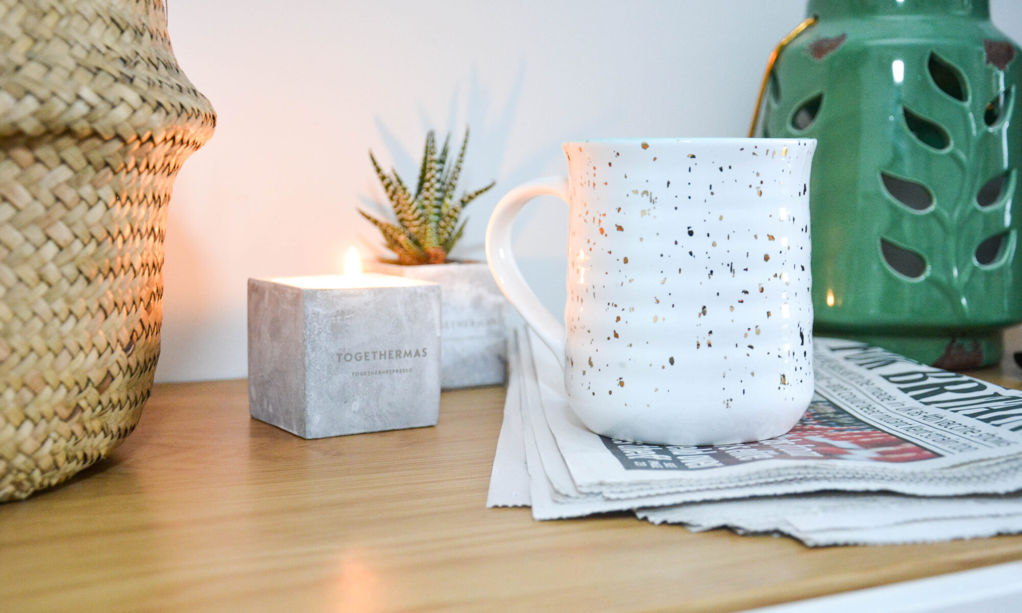 Nespresso coffee mug and candle on desk