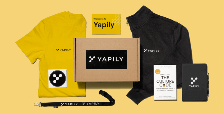Fintech merchandise yellow background featuring tshirt, boxs and lanyards all branded
