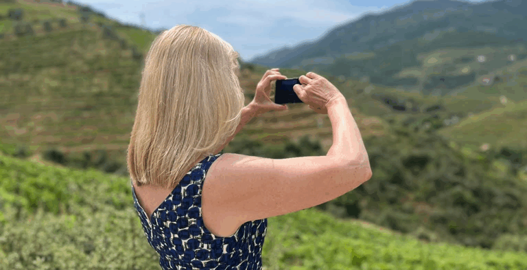 Image: Julia Molloy, Finance Manager, Swagpack with a camera looking out over rolling gfeen hills
