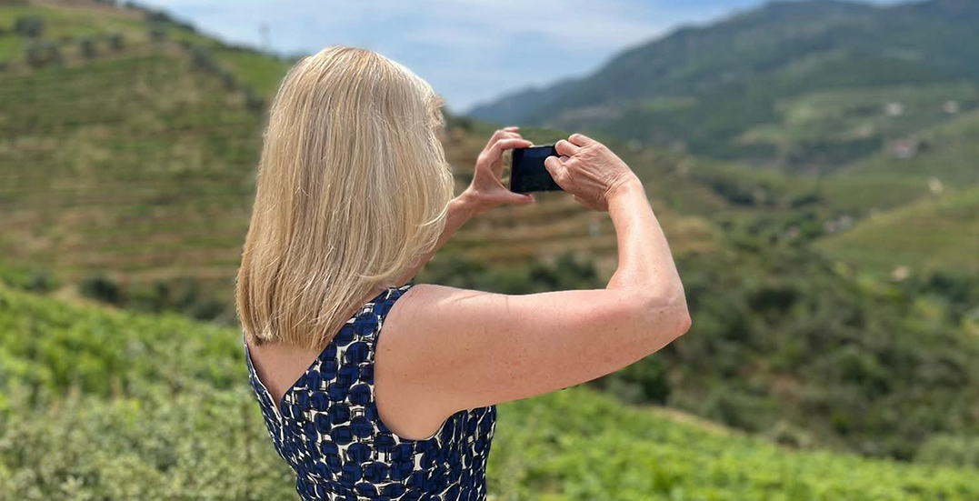 Image: Julia Molloy, Finance Manager, Swagpack with a camera looking out over rolling gfeen hills